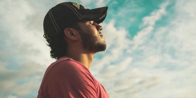 Man taking a breath with eyes closed on an overcast day