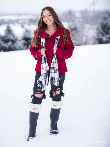 a woman taking picture in the snow