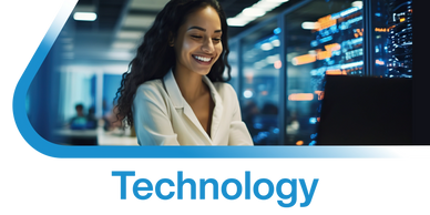 Smiling woman working on a laptop in a high-tech environment.