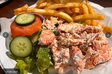 Lobster salad with fresh veggies and seasoned fries.