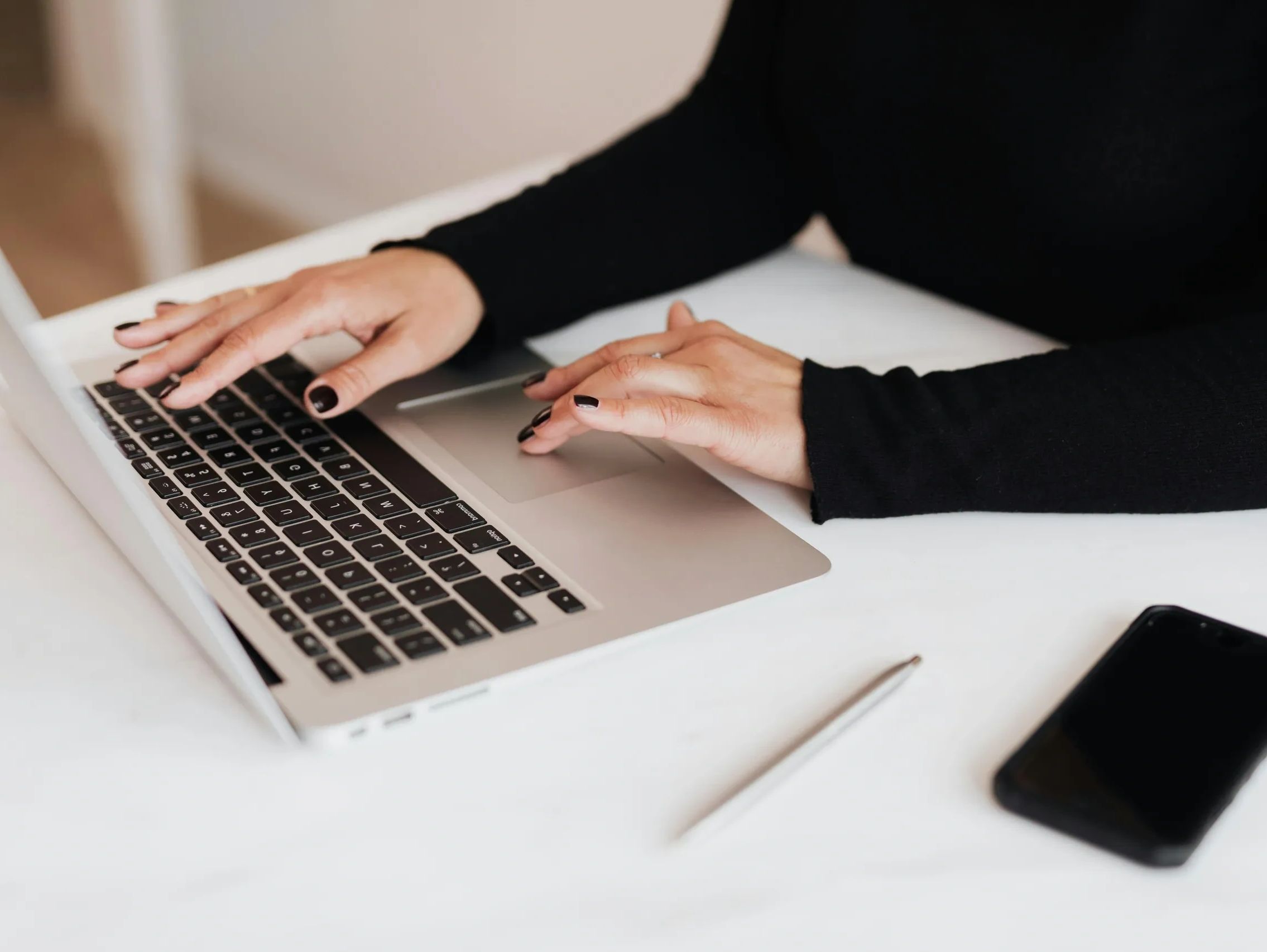 Person typing on computer.