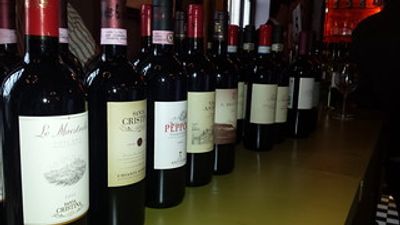A row of wine bottles lined up on a counter.