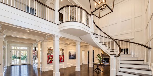 Custom curved staircase, hand-built on site, in a Greenwich CT entry hall by Jeff Scalise Building