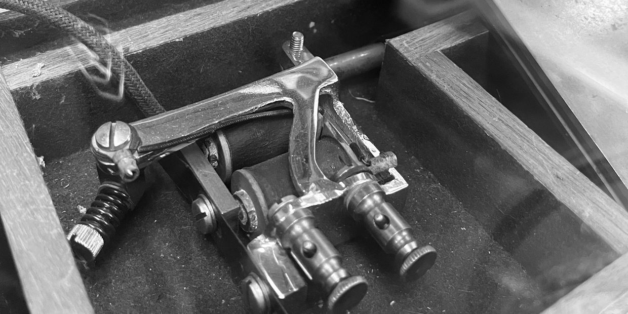 Close-up of a mechanical device inside a wooden frame.