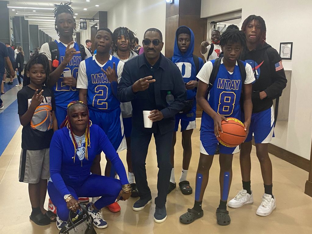 Dominion Youth middle school male basketball players pose with actor Clifton Powell