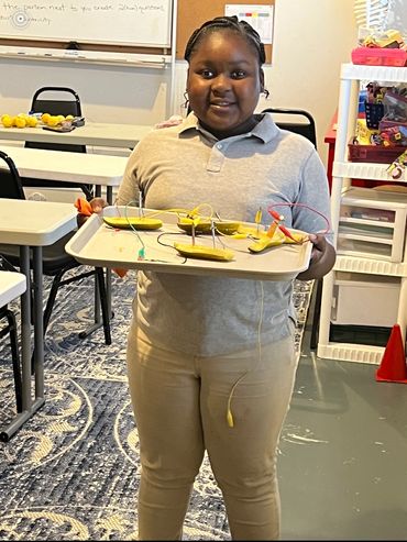 Dominion Youth student makes a battery out of a pickle in the STEM lab.