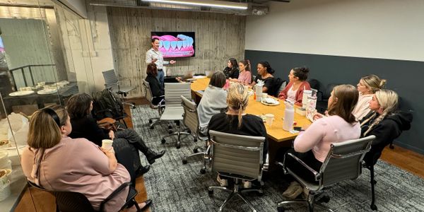 A group attending a presentation in a modern conference room.