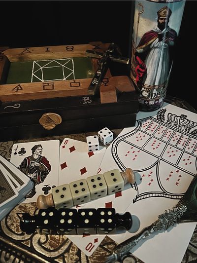 A collection of gaming items including cards, dice, and a wooden board.