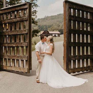 Bride and Groom on wedding at in front of gate and venue at Robbins Paradise Ranch