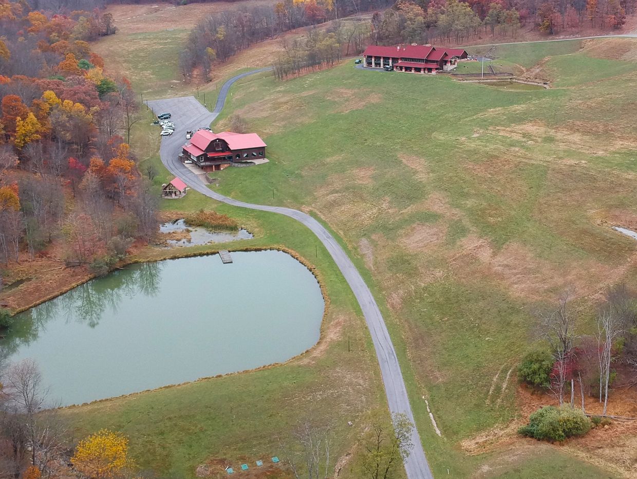 Drone picture of Robbins Paradise Ranch. Includes the ranch, the Chalet - venue - and a large pond. 