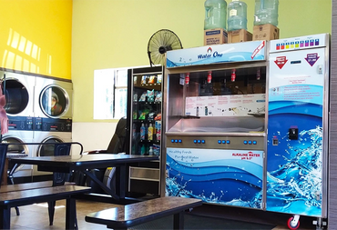 Commercial water vending machine (model ws-3000) in coin laundry with gold and green wall
