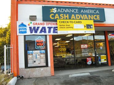 check cashing storefront with water service sign