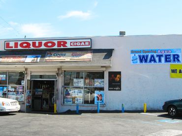 liquor storefront with water service sign on wall