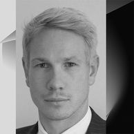 Black and white portrait of a man with light hair and a suit.