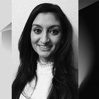 Black and white portrait of a smiling woman with long dark hair.