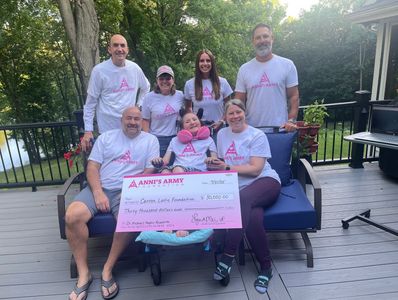 Group of people holding a large check from Ann's Army.