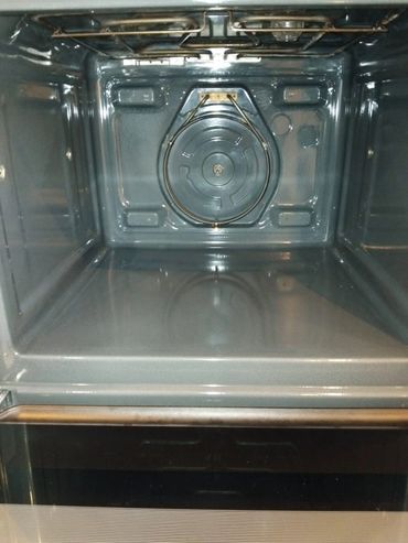 Clean, empty oven interior with visible heating elements.