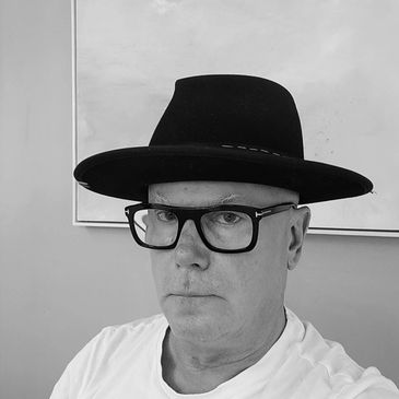 Man wearing a black hat and glasses.