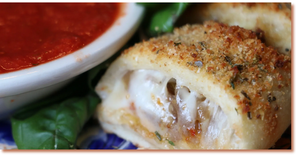 BanginBoli served on a decorative plate with green and red bell peppers and basil leaves.
