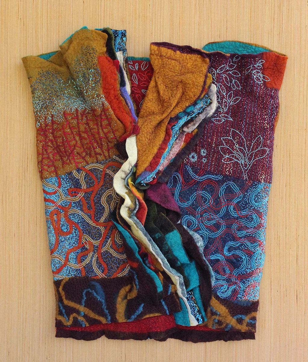 Wrapped in Earth, Sky, and Water, 
Artist-made wool felt, hand embroidery, wood