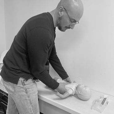 Sean learning how to do infant CPR.