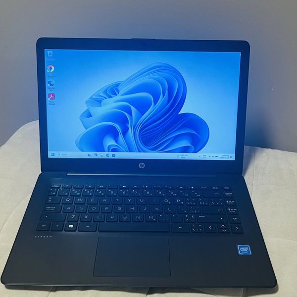 HP laptop with Windows 11 on screen.