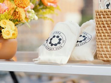 White bags with a logo on a table.