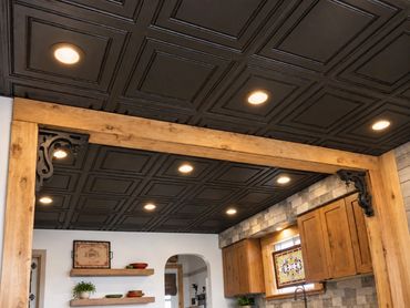 Retouched project photograph of recessed lights in a dark coffered ceiling.