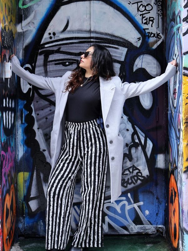 Urban fashion portrait of Leah posing against graffiti walls in Toronto by David Photography.