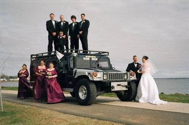 An entourage beside a car
