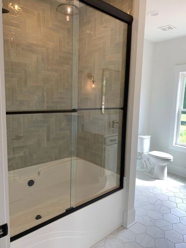 Alumax semi-frameless by-passing doors. Black frame/ Clear glass