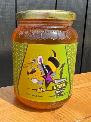 Jar of honey with a colorful bee playing a guitar on the label.