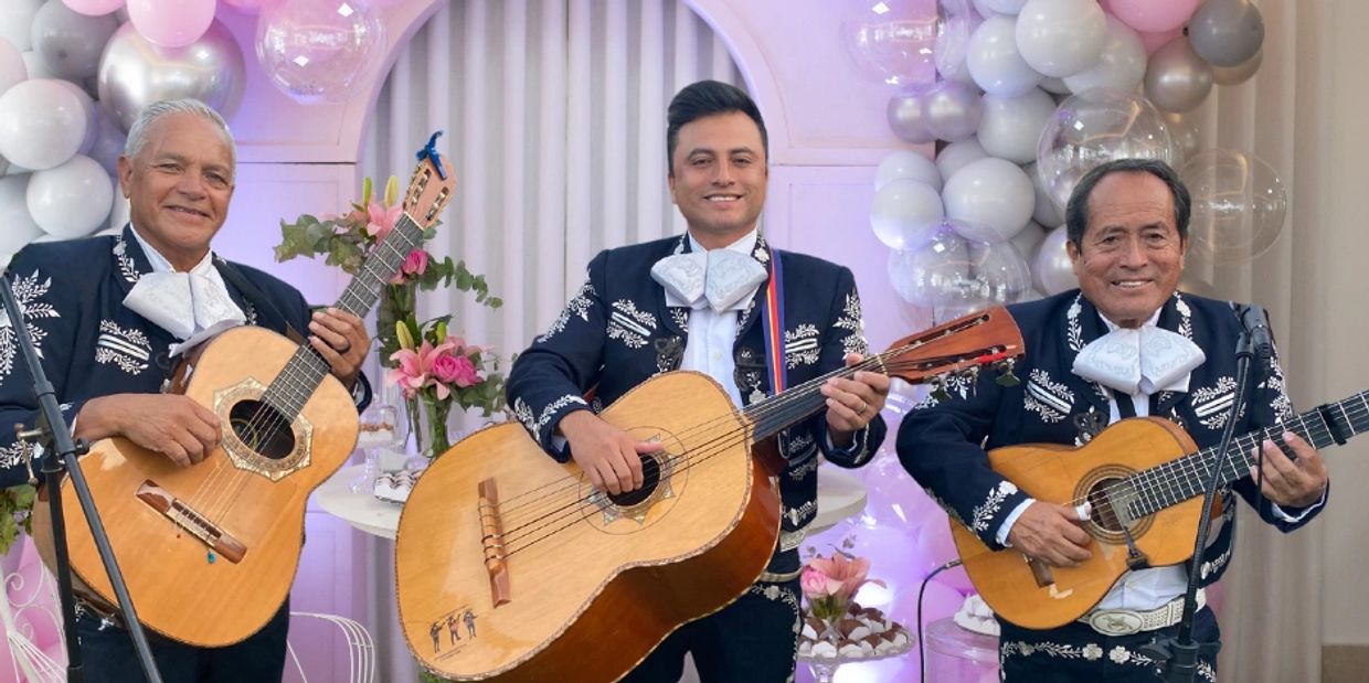 Trio mariachi capri performing at a birthday party