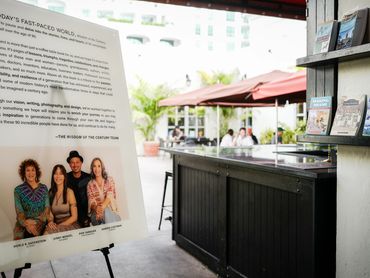 Wisdom of the Century team on a sign