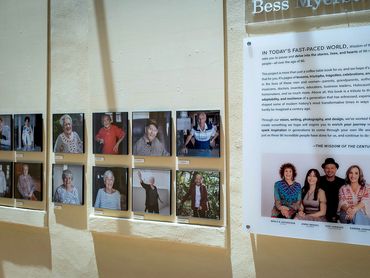 Photo exhibition of elders on yellow wall