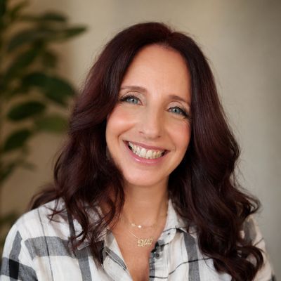 Smiling woman with long brown hair.
