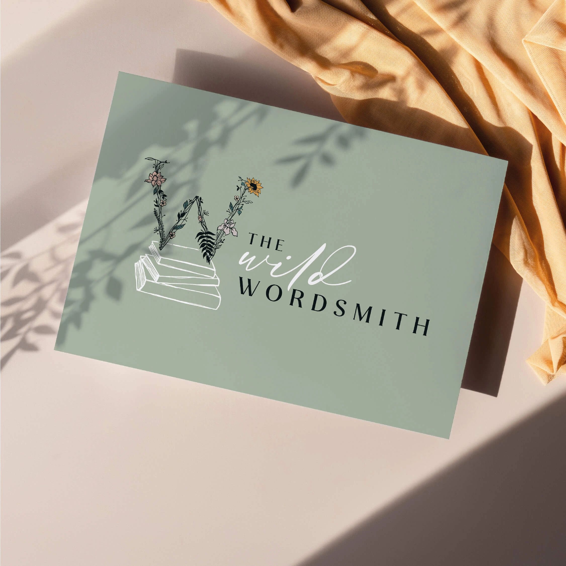 the wild wordsmith branding on a green business card