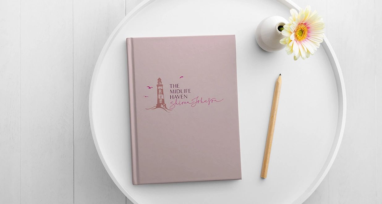 The midlife haven logo on a pink book cover