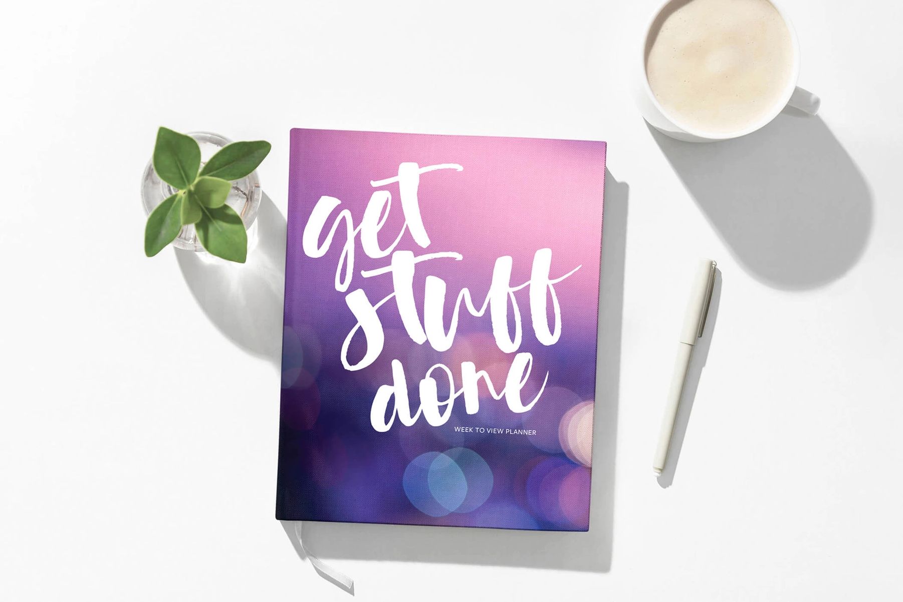 front cover of planner Get stuff done colour purple with a mug of coffee a plant and a white pen
