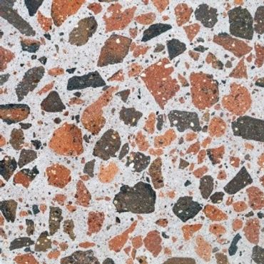 Close-up of recycled brick terrazzo flooring with mixed stone chips.
