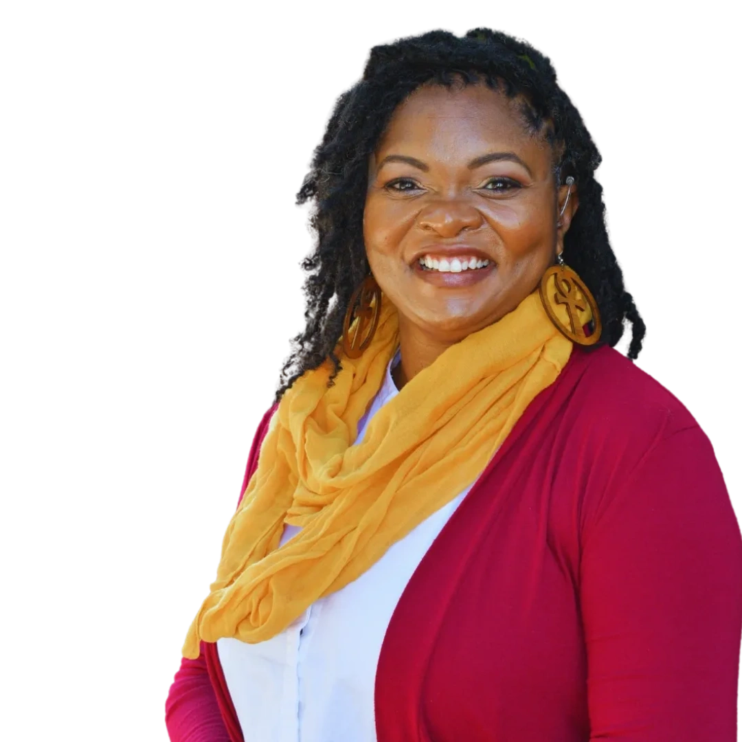 Black Woman smiling, wearing gold scarf, white shirt, burgundy sweater, large wood earrings.