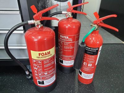Red fire extinguishers that have been recently serviced.