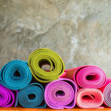 Stacked colorful yoga mats.