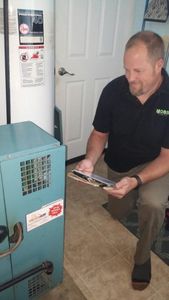 Picture of owner, David Moench inspecting a boiler.