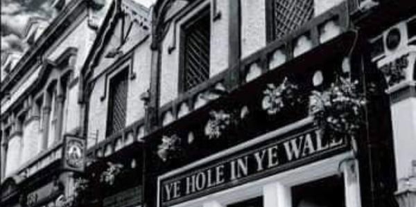 Black amd white image of the outside of Ye Hole In Ye Wall pub
