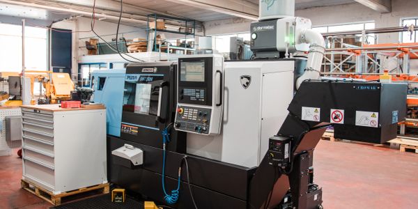 Advanced CNC machining center in a spacious industrial workshop.