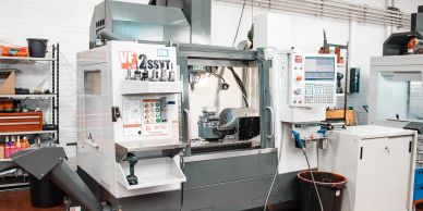 Industrial CNC milling machine in a workshop environment.