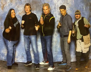 The Cast from Cobra Kai w/our Cobra wand that we painted the colors of the Cobra Kai Logo 