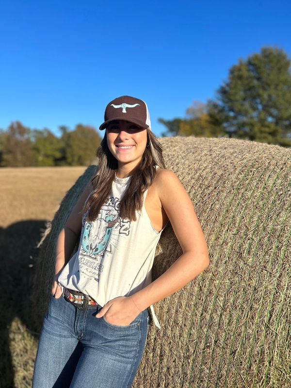 Person wearing GRAB'EM BY THE HORNS baseball cap