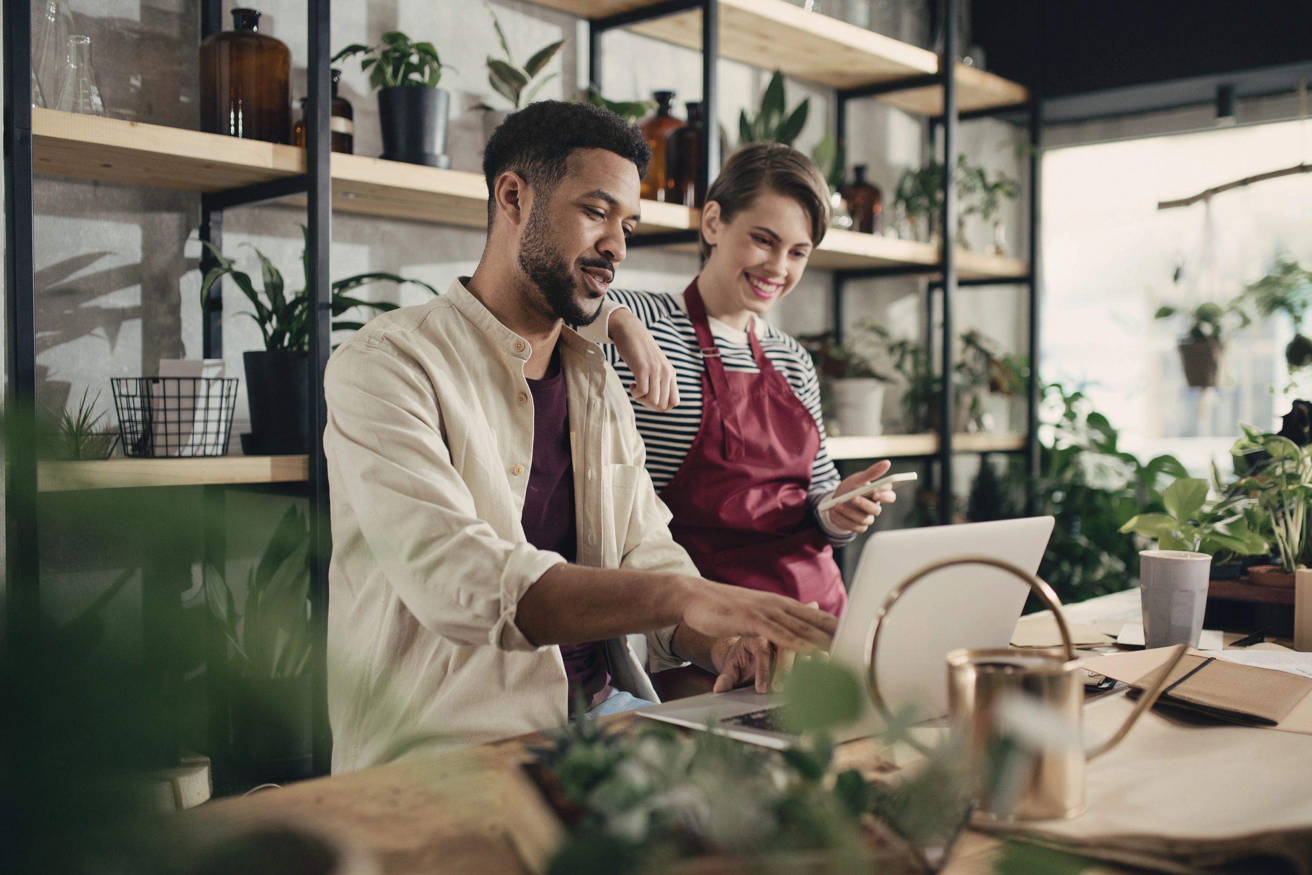 Small business owner discussing with employee